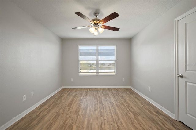 unfurnished room with wood-type flooring and ceiling fan