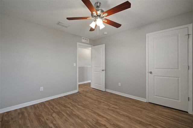 unfurnished bedroom featuring dark hardwood / wood-style flooring and ceiling fan