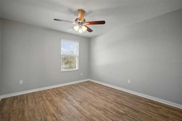 empty room with hardwood / wood-style floors and ceiling fan