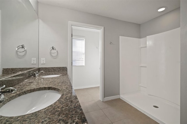 bathroom with vanity, tile patterned floors, and walk in shower