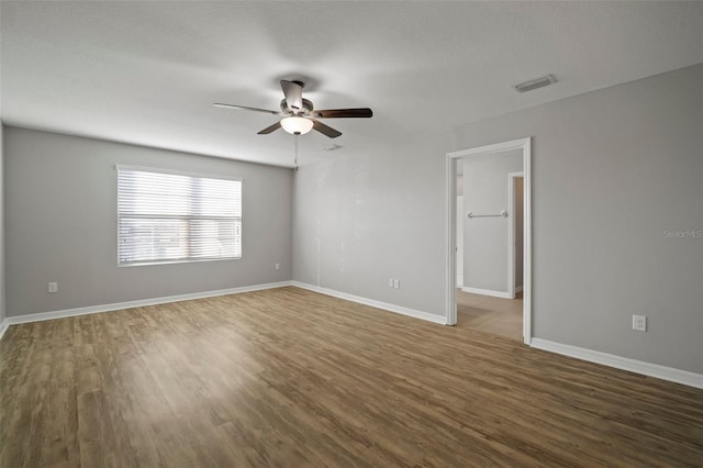 unfurnished room featuring a textured ceiling, wood-type flooring, and ceiling fan