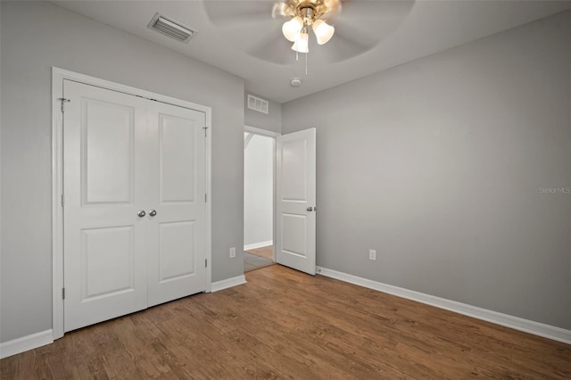 unfurnished bedroom with light hardwood / wood-style floors, ceiling fan, and a closet