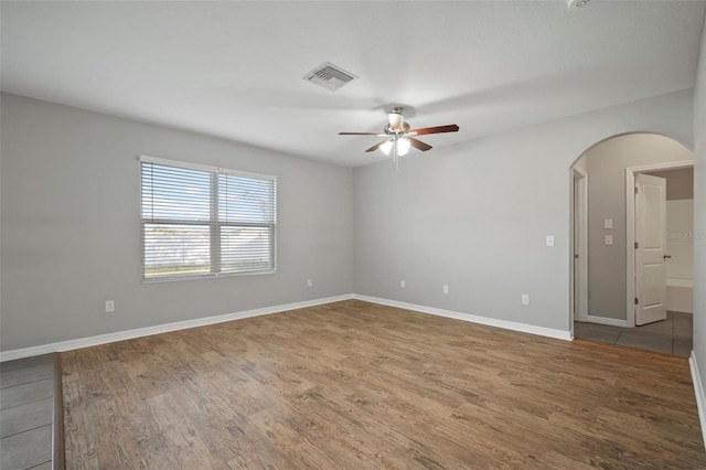 spare room featuring hardwood / wood-style flooring and ceiling fan