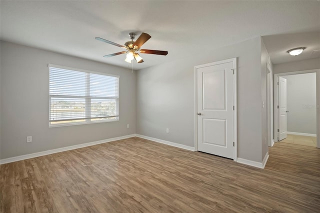 spare room featuring hardwood / wood-style floors and ceiling fan