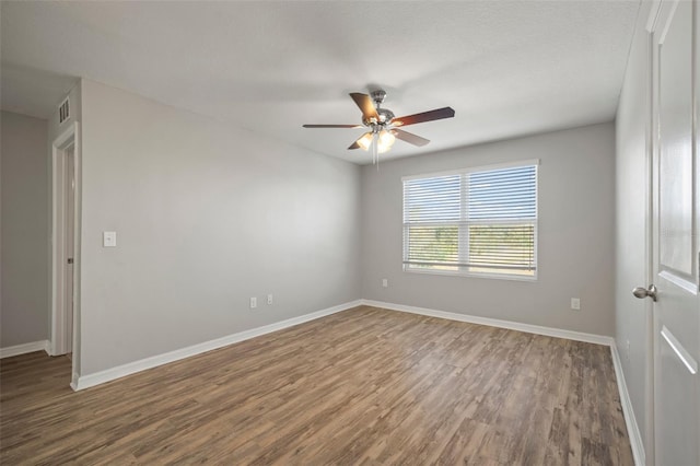 unfurnished room with ceiling fan and wood-type flooring