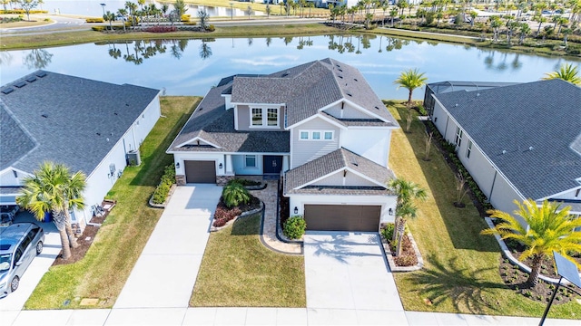 birds eye view of property with a water view