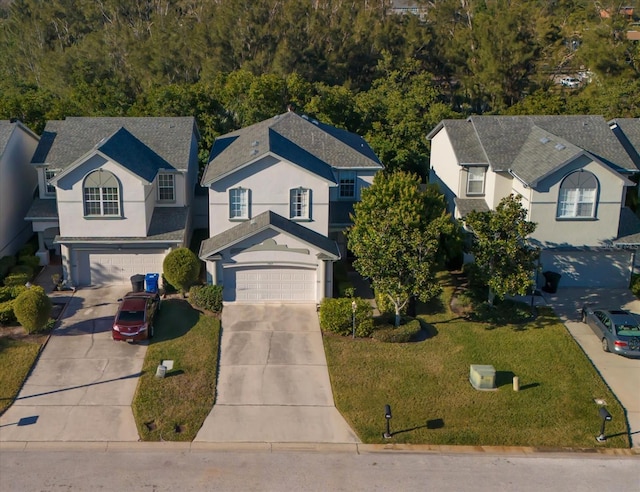 view of front of house with a garage and a front lawn