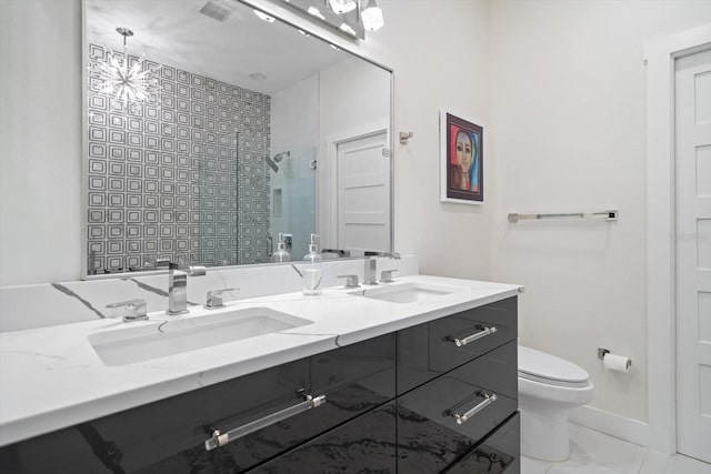 bathroom featuring tile patterned floors, toilet, a shower with shower door, a chandelier, and vanity