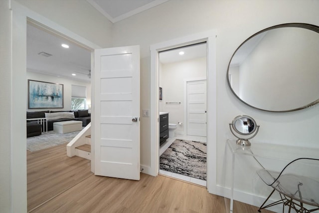 bathroom featuring ornamental molding, hardwood / wood-style floors, and vanity