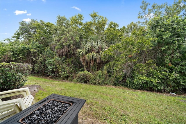 view of yard with an outdoor fire pit