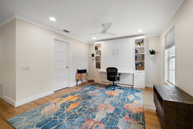 office space with crown molding, ceiling fan, and light wood-type flooring