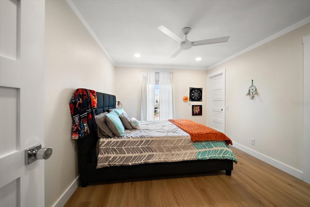 bedroom featuring wood-type flooring, ornamental molding, and ceiling fan