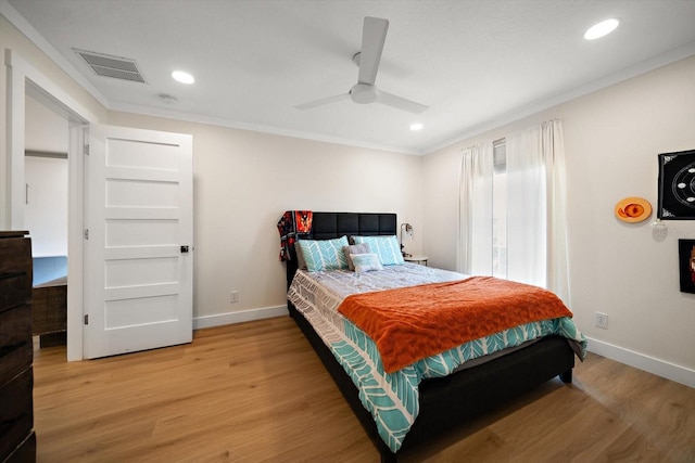 bedroom featuring crown molding, hardwood / wood-style floors, and ceiling fan