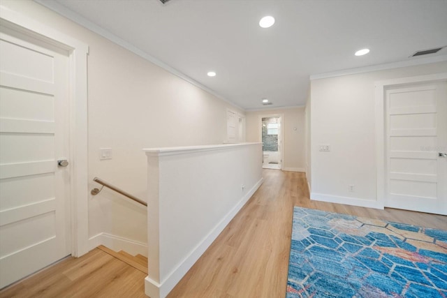 hallway with hardwood / wood-style flooring and crown molding