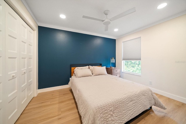 bedroom featuring ceiling fan, a closet, and light hardwood / wood-style flooring