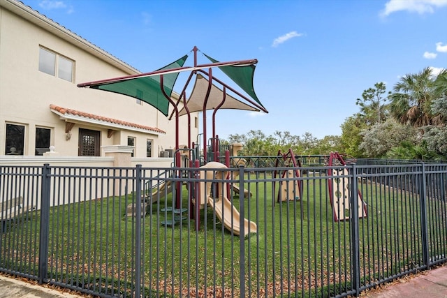 view of playground with a lawn