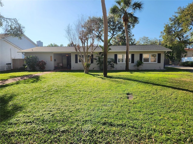 ranch-style home featuring a front yard