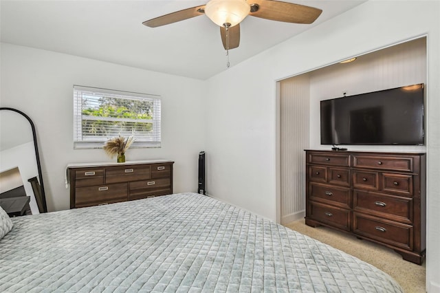 bedroom featuring light colored carpet and ceiling fan