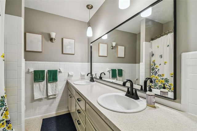 bathroom with vanity and tile walls