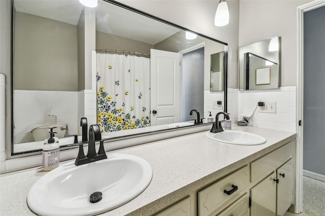 bathroom featuring vanity and tasteful backsplash