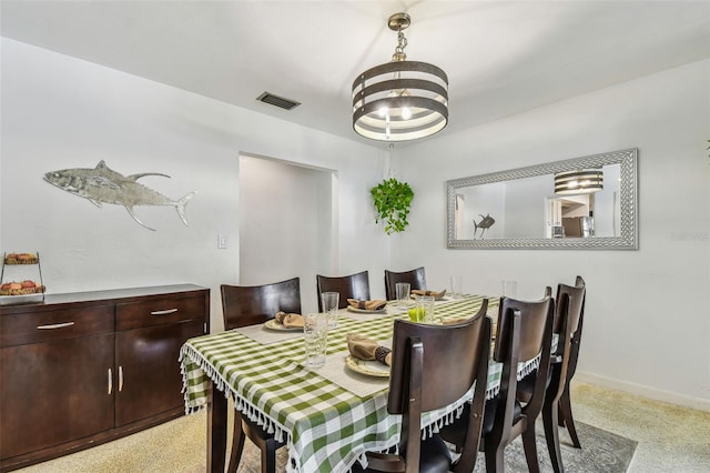 dining space with an inviting chandelier