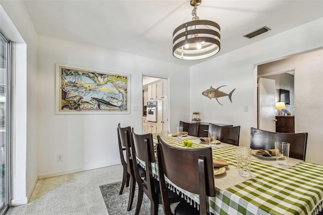 dining space featuring a notable chandelier