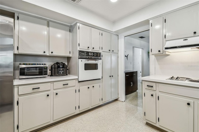 kitchen featuring white cabinets and appliances with stainless steel finishes