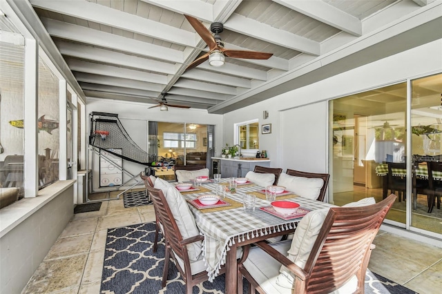 dining room with beamed ceiling and ceiling fan