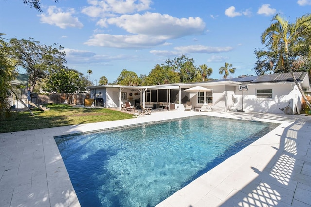 view of swimming pool featuring a lawn and a patio