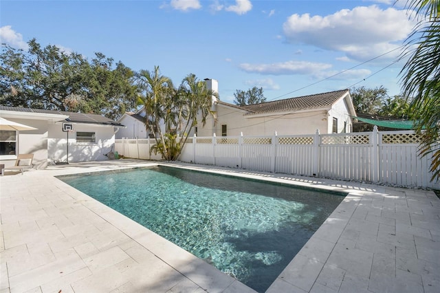 view of swimming pool featuring a patio area