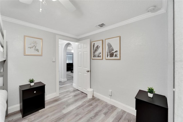 interior space with crown molding and light hardwood / wood-style floors