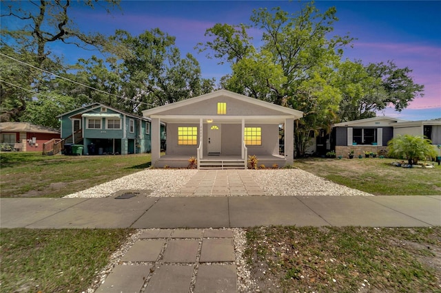 view of front of property with a yard and covered porch