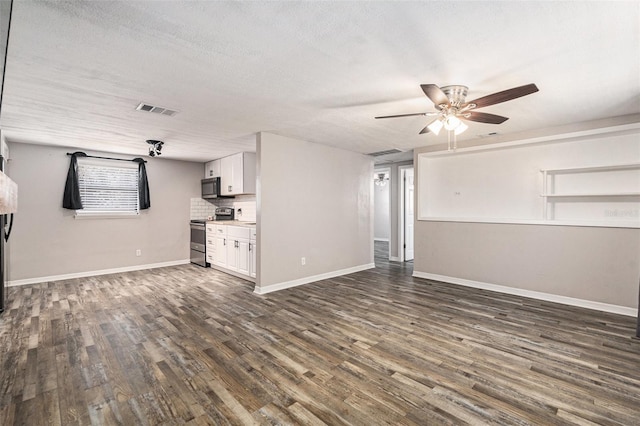 unfurnished living room featuring ceiling fan, dark hardwood / wood-style floors, and a textured ceiling