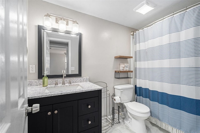 bathroom featuring vanity, toilet, and a shower with shower curtain