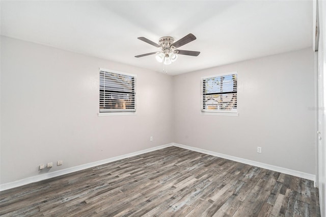 empty room featuring dark hardwood / wood-style flooring and ceiling fan