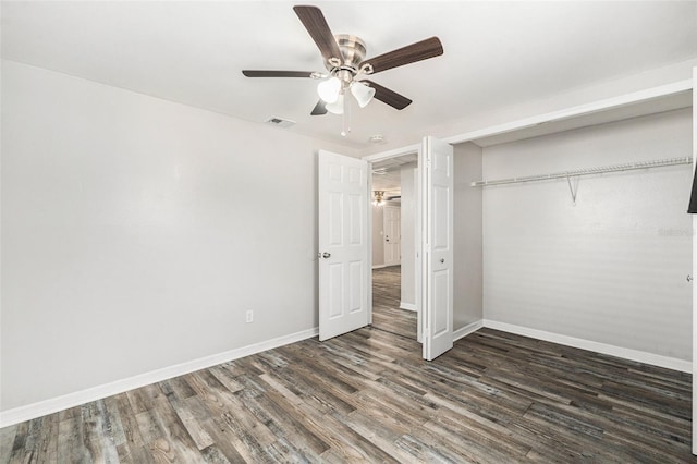 unfurnished bedroom featuring dark wood-type flooring, ceiling fan, and a closet