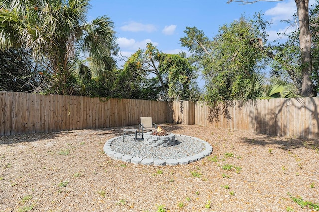 view of yard with a fire pit