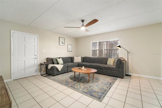 tiled living room featuring ceiling fan and a textured ceiling