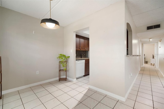 interior space with light tile patterned floors and sink