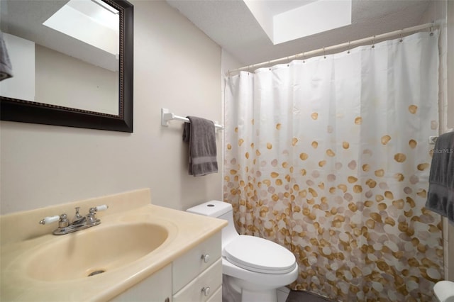 bathroom featuring vanity, toilet, and a shower with shower curtain