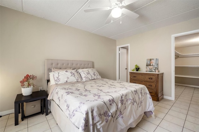 bedroom with light tile patterned flooring, a textured ceiling, and ceiling fan