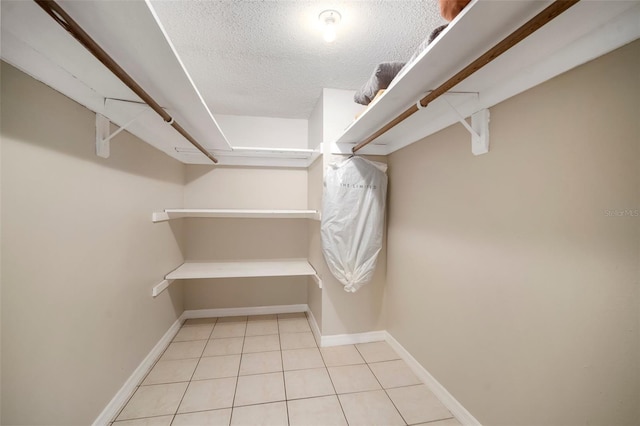 spacious closet with light tile patterned flooring