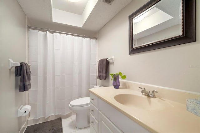 bathroom featuring vanity, tile patterned flooring, and toilet