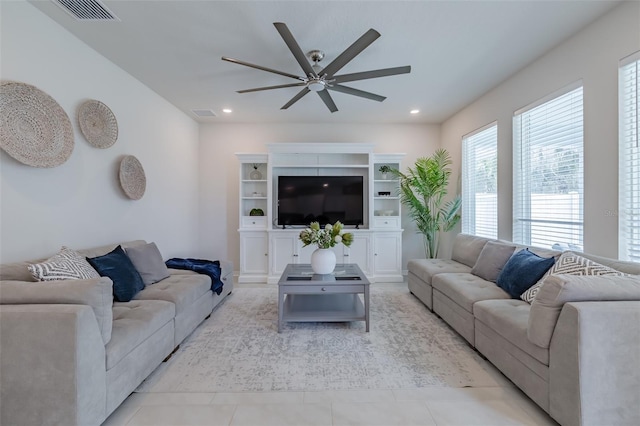 living room featuring light tile patterned flooring and ceiling fan