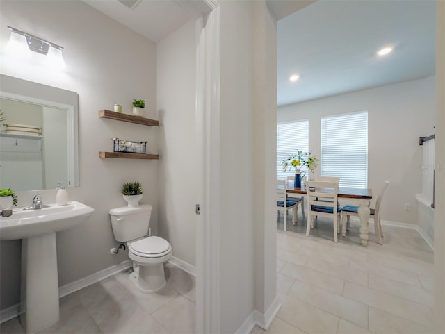 bathroom featuring sink, tile patterned floors, and toilet