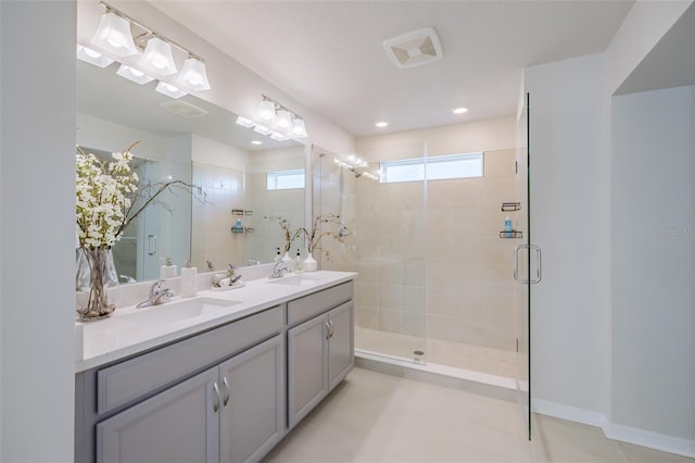 bathroom with vanity and a shower with door