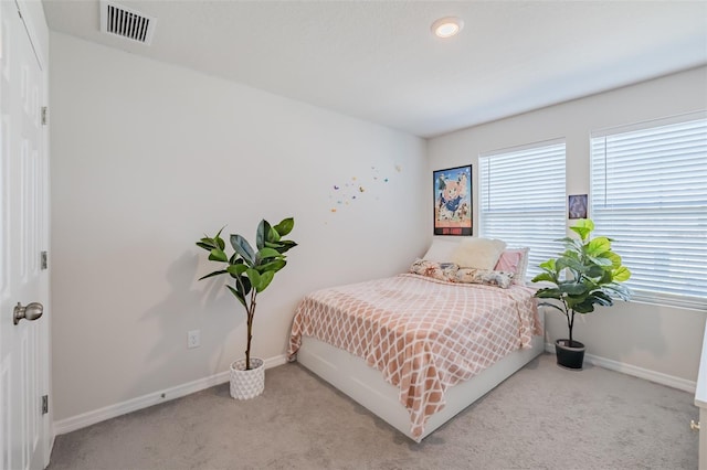 bedroom featuring light colored carpet