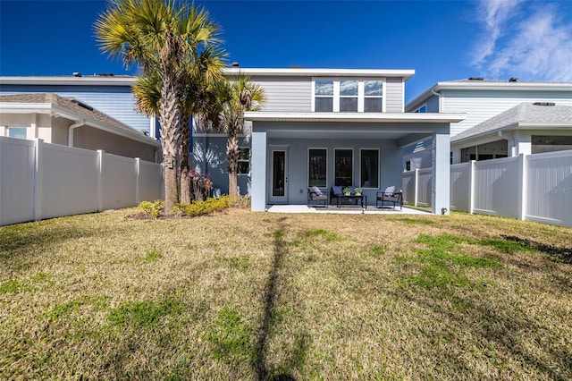 back of house featuring a patio and a lawn