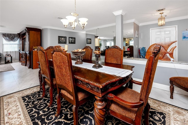 dining area featuring ornamental molding, decorative columns, and a chandelier