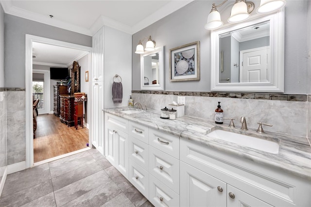 bathroom with crown molding, vanity, and tile patterned flooring